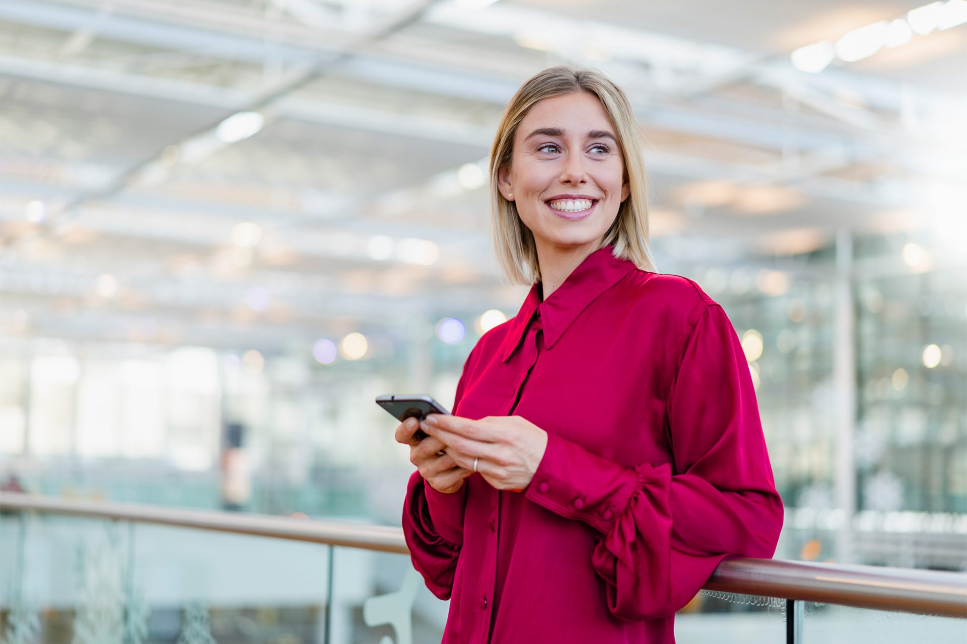 woman-in-red-with-phone-smiling